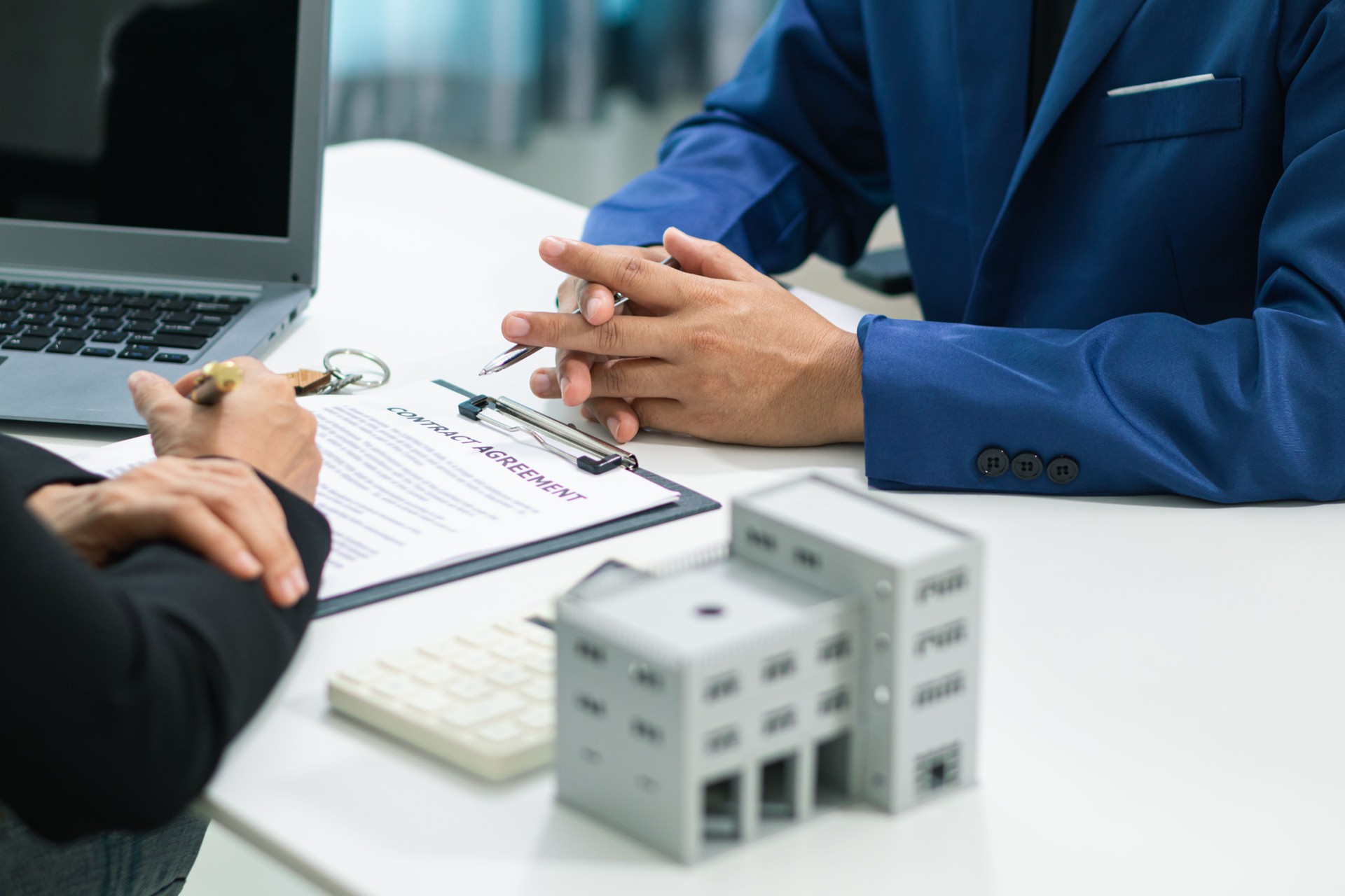 Real estate agent is talking to customer to present promotion for signing contract buy and selling real estate in company project in real estate office. present promotion to make customer decide buy.