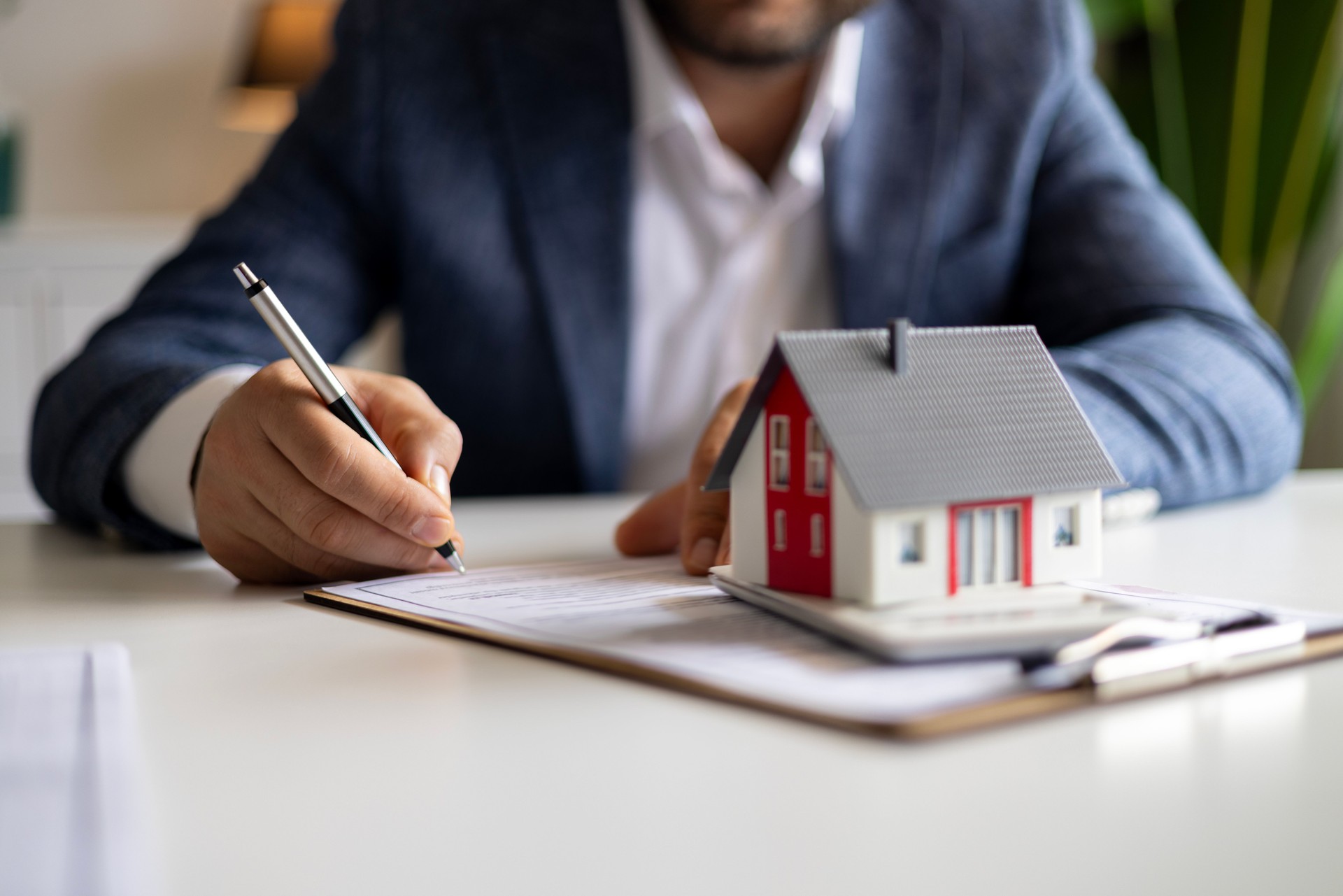 Real estate agent discuss about the terms of the home purchase agreement and asked the customer to sign the documents to make the contract legally, Home sales, lease, mortgage and home insurance.